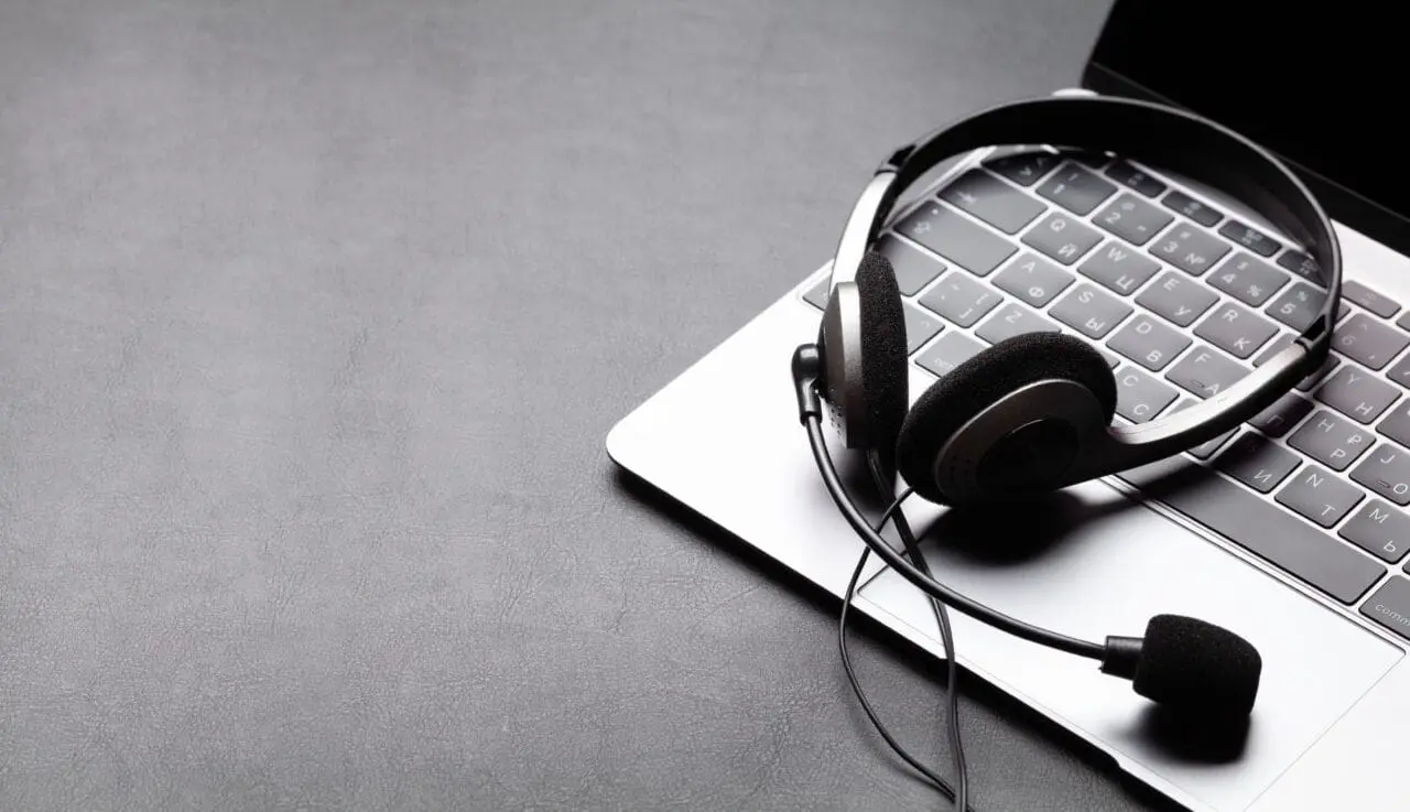 Office desk with headset and mac laptop