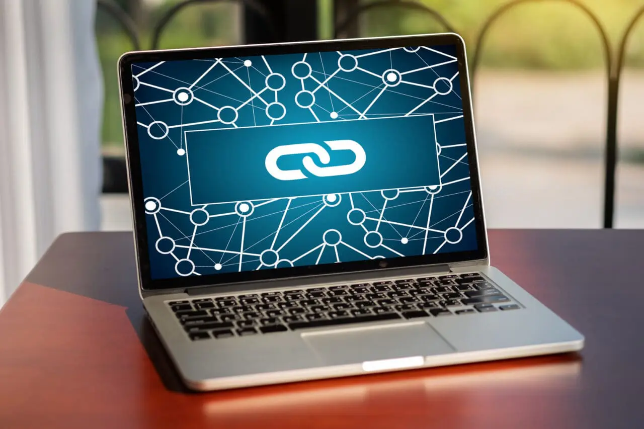 Open Mac laptop with Backlink logo on screen