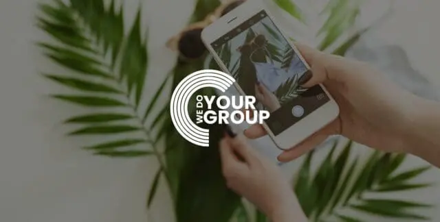 WeDoYourGroup white logo on background of woman taking photo of plant on her mobile phone