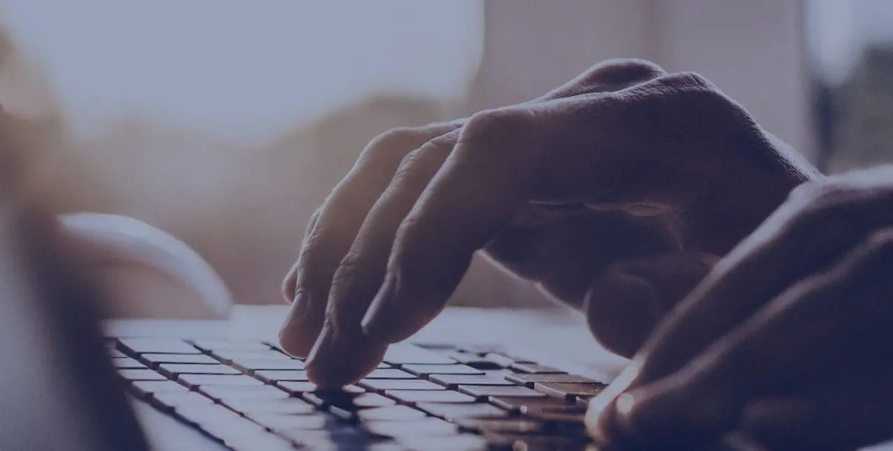 Man hands typing on computer keyboard closeup, digital marketing apprentice
