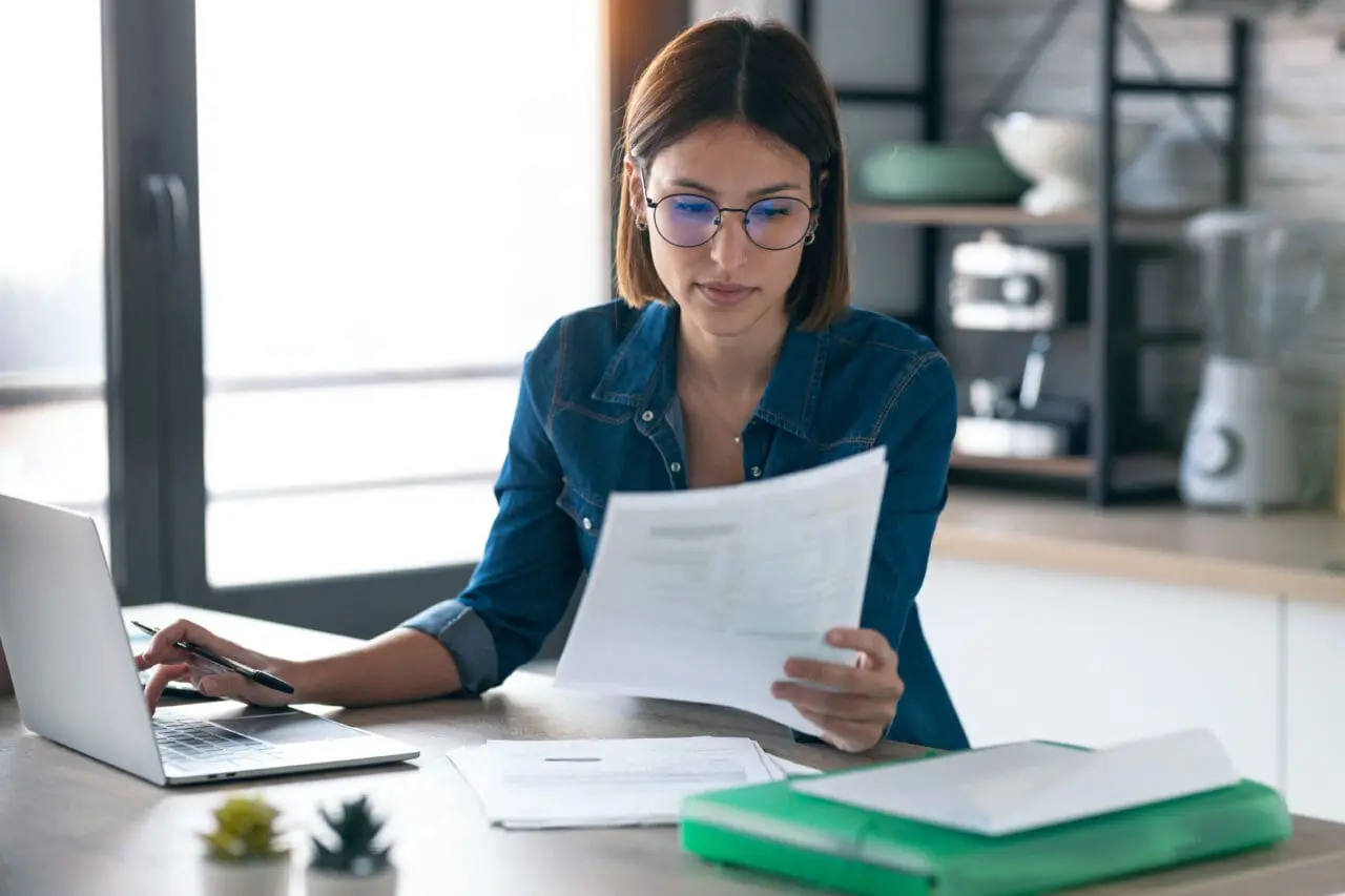 young woman working with computer while consulti