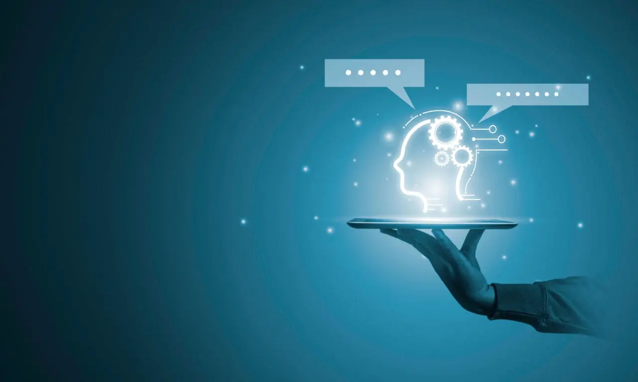 Hand holding tablet with with AI or Artificial Intelligence message for chatbot by Open AI concept.