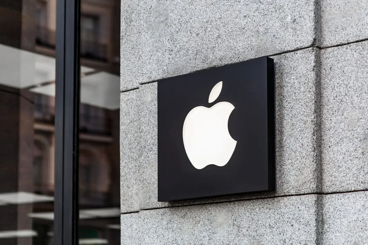 apple company logo on a grey brick wall