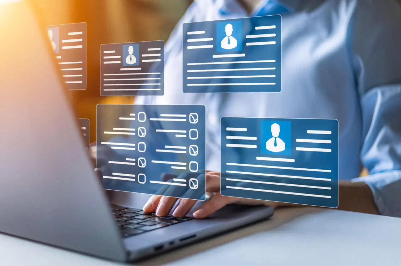 Human resources and management concept. Employees must complete the online survey form answer the test questions. Marked checklist on a clipboard. HR manager checking the employees profiles on laptop