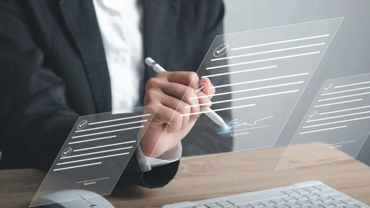 Digital Signature or e-signature and Paperless workplace concept. Businessman using stylus pen write signing on virtual screen document file acceptance work on network connection.