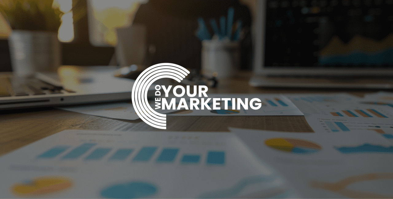 a desk in the we do your marketing office with analytics and customer journey maps on it