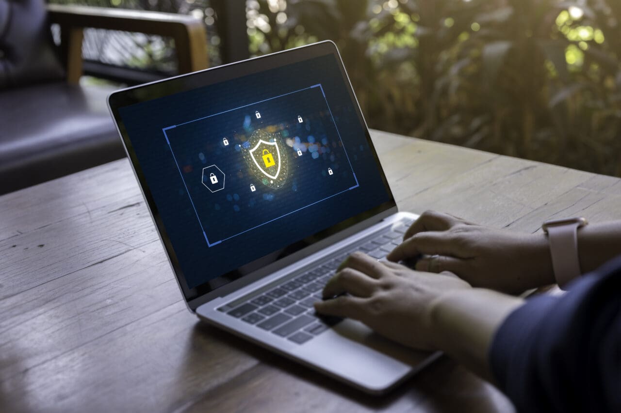 Person using a Laptop Computer with data protection, Cyber security, information safety and encryption concept. internet technology and business concept, Laptop mockup with clipping path on screen.