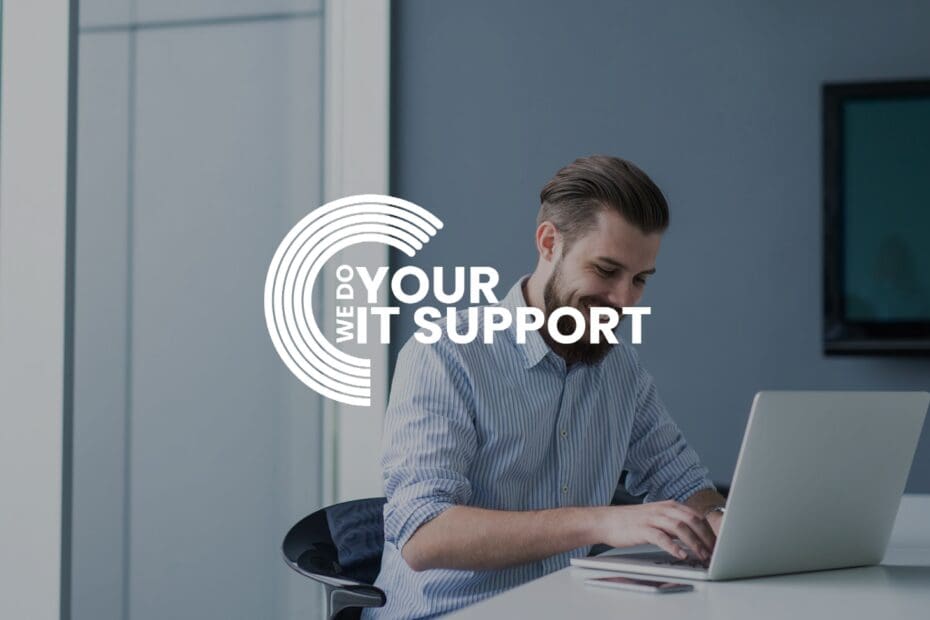 WeDoYourITSupport white logo on background of man working from home on Mac laptop, smiling