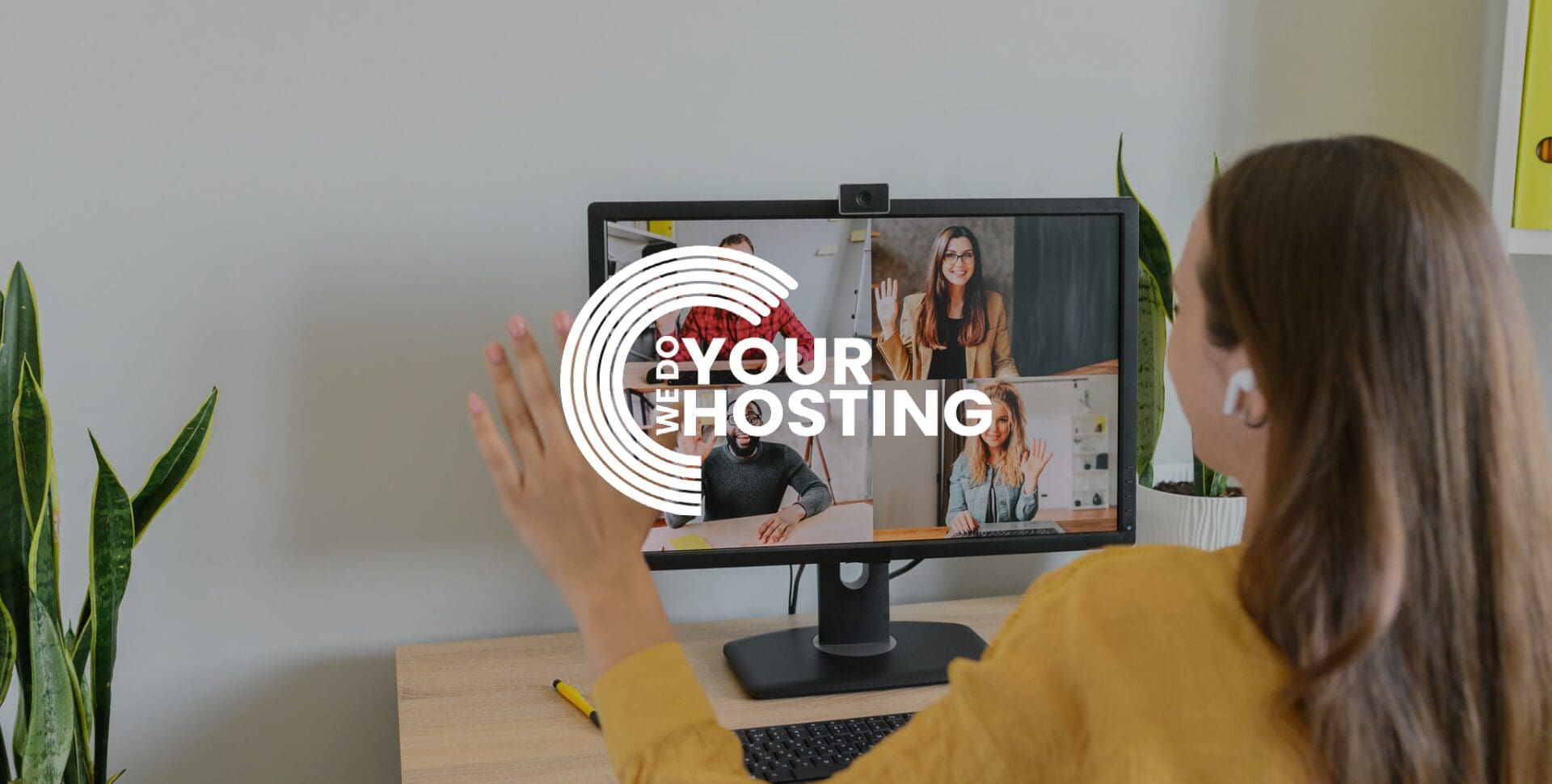 WeDoYourHosting white logo on background of woman at home, on a meeting video call with colleagues on her computer