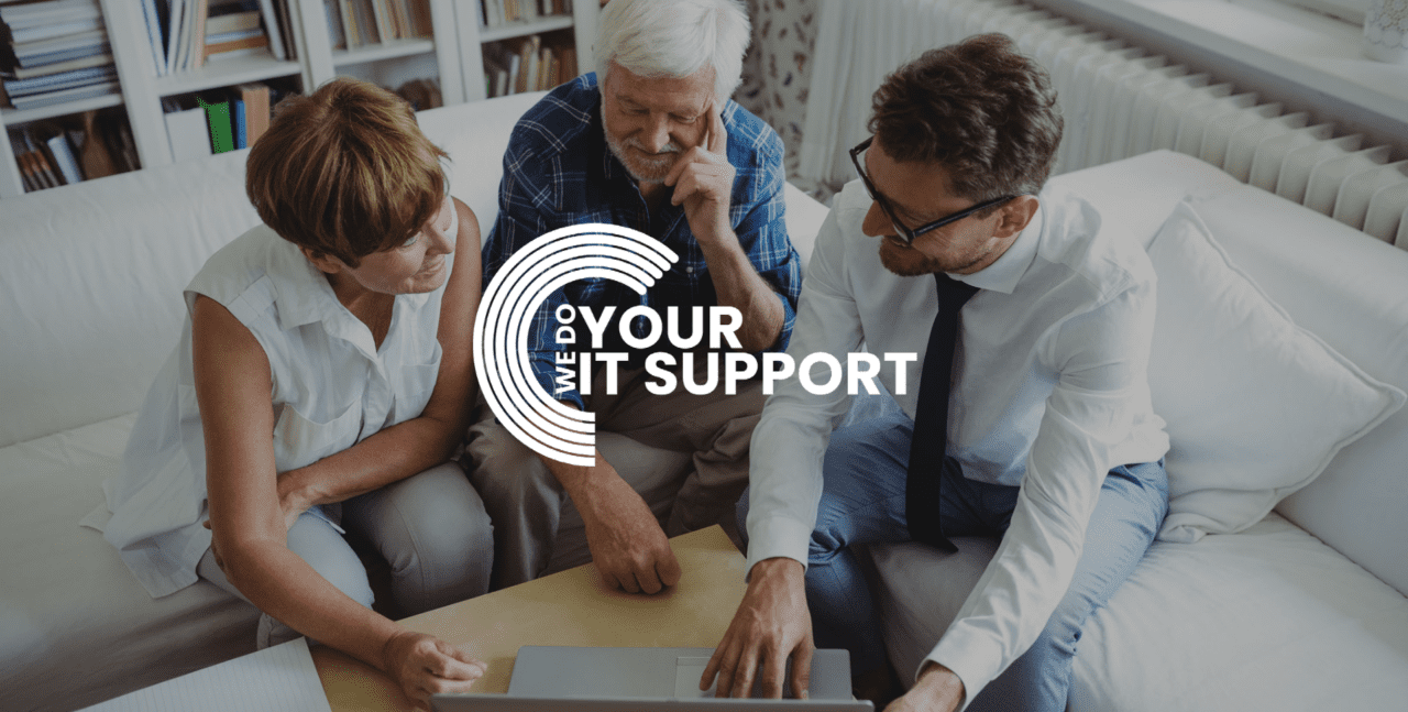WeDoYourITSupport white logo on background of young business man speaking with elderly couple, looking at laptop