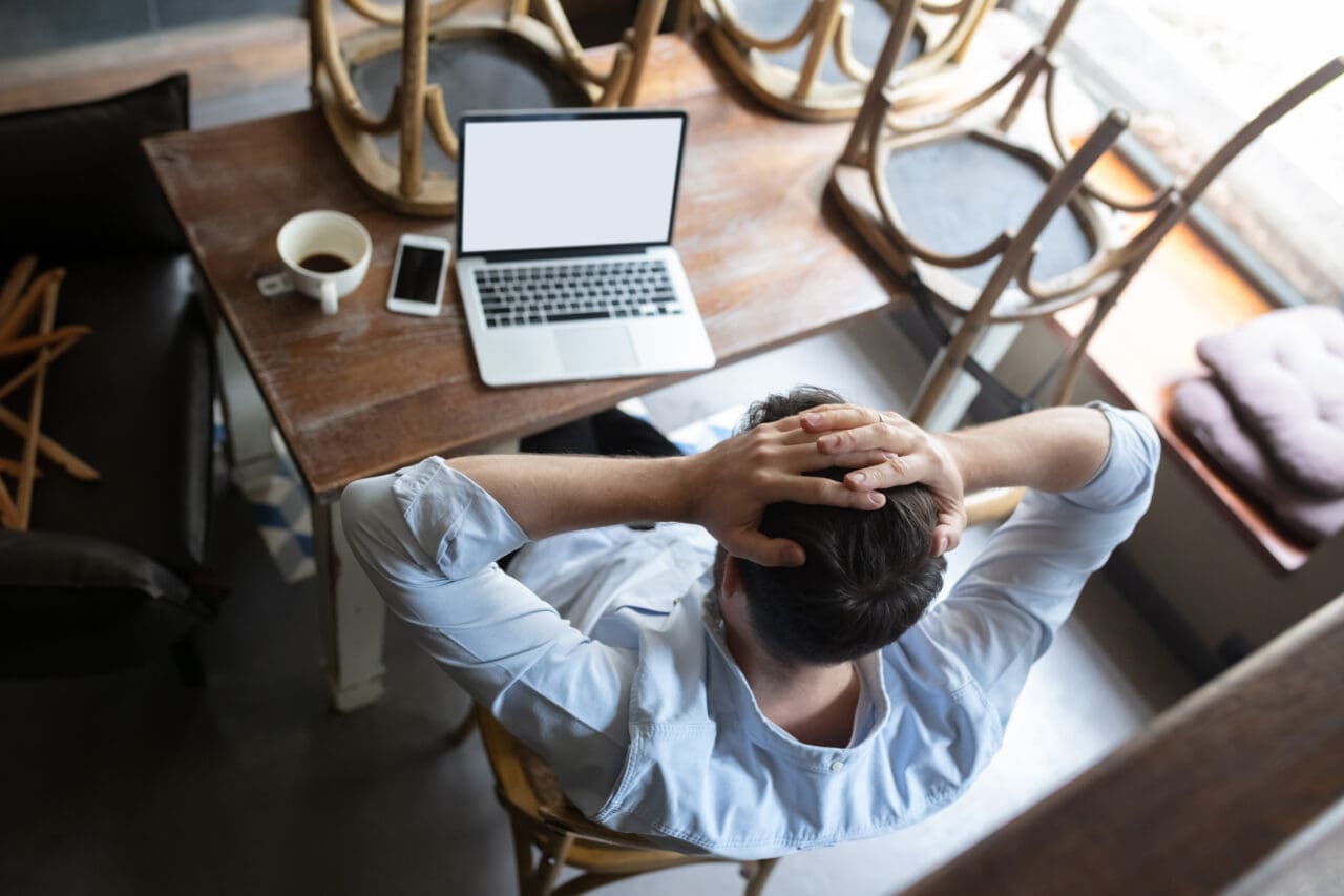 Restaurant, cafe, bar closed due to COVID-19 or Coronavirus outbreak lockdown, stressed owner of small business trying to find solution, top view