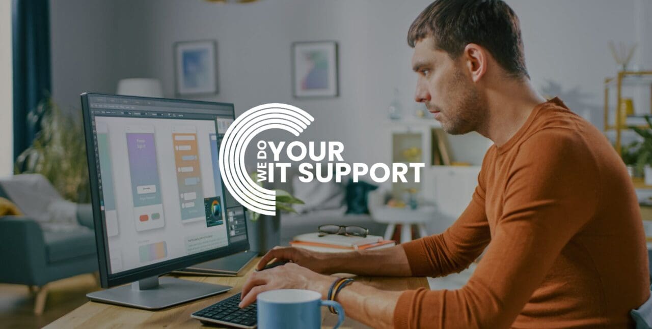 WeDoYourITSupport white logo on background of man sat at desk working from home on computer