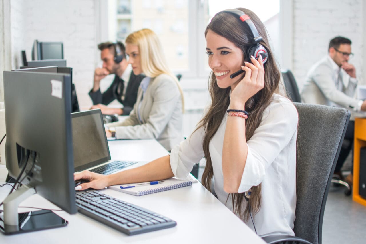 Friendly smiling woman call centre operator with headset