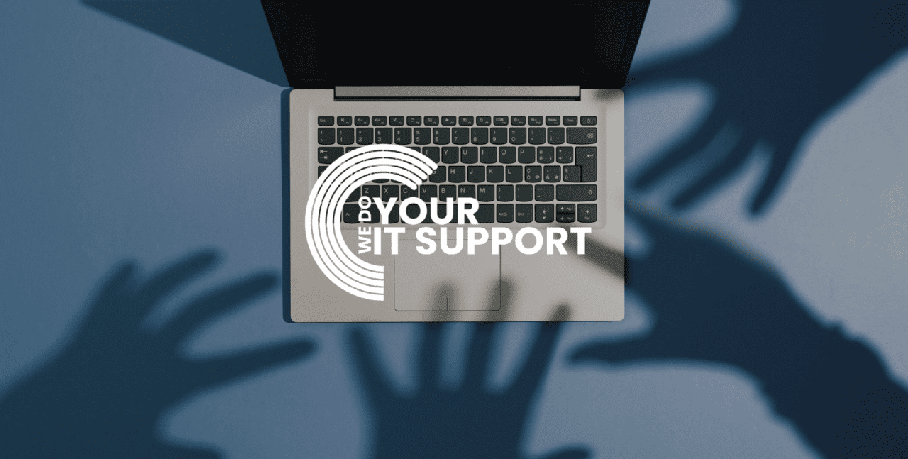 WeDoYourITSupport white logo on background of a Mac laptop placed on a blue background with shadows of hands