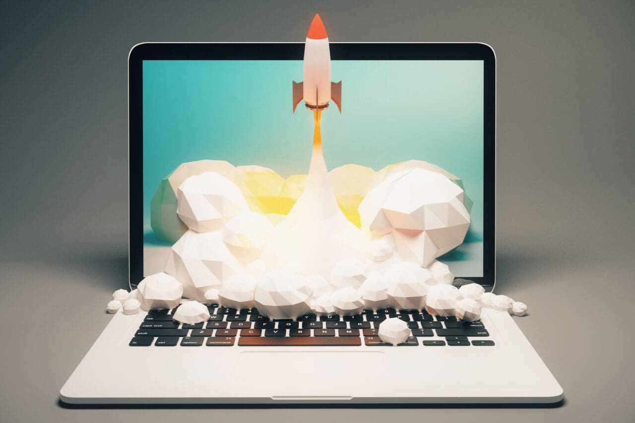 Startup concept - Rocket being launched from a laptop screen