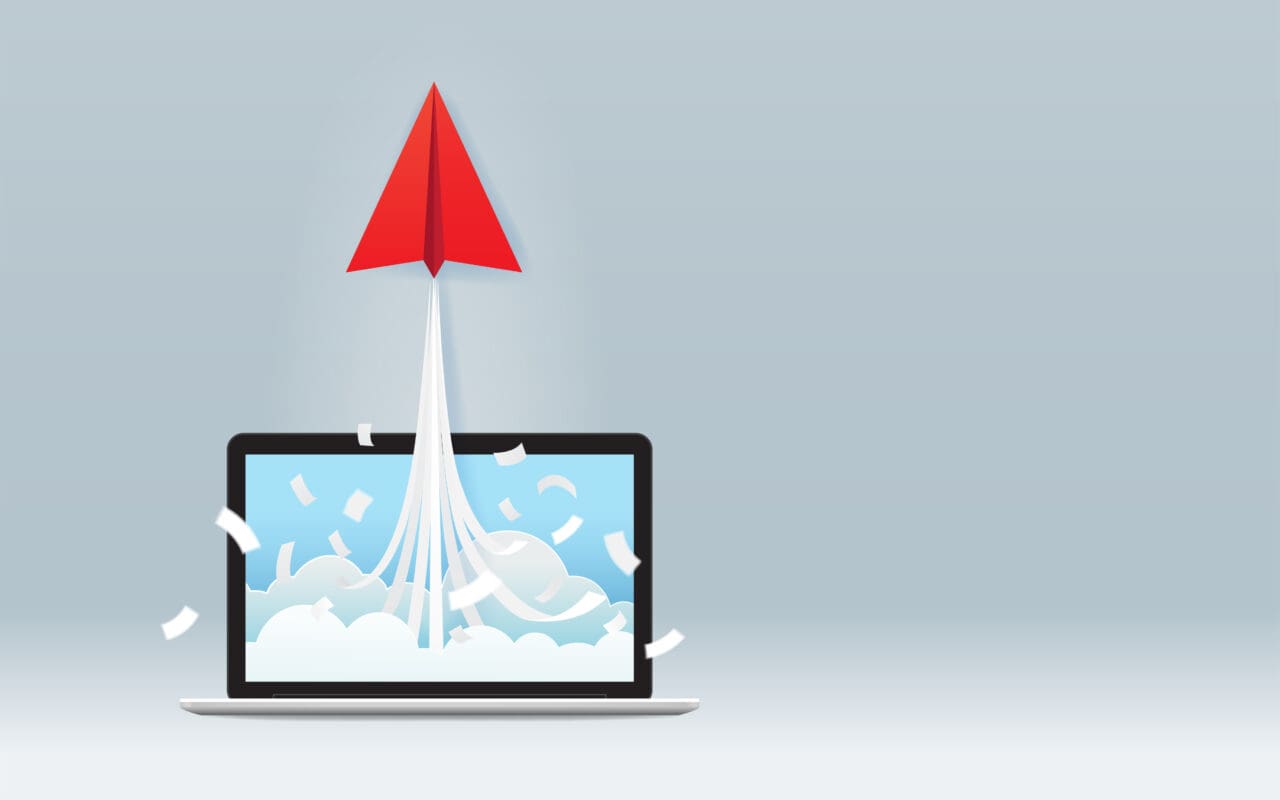 Startup business project concept with red paper plane launching from computer screen
