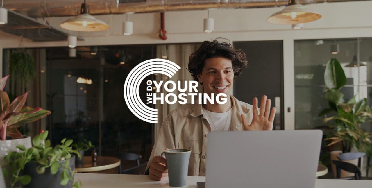 WeDoYourHosting white logo on background of man smiling and waving at his laptop - On video call