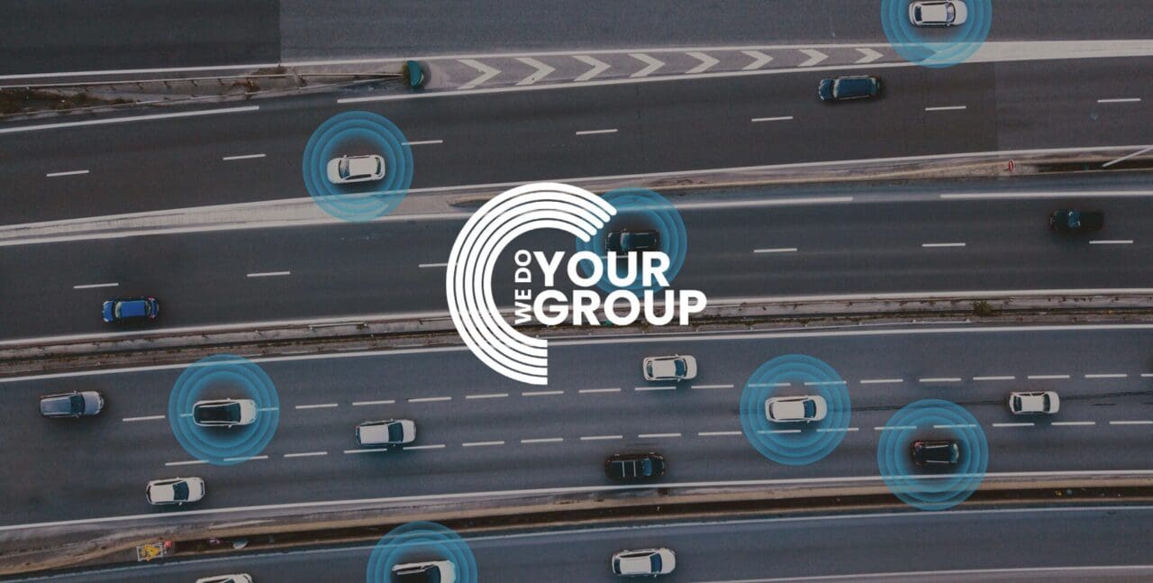 WeDoYourGroup white logo on background of birdseye view of cars driving down road