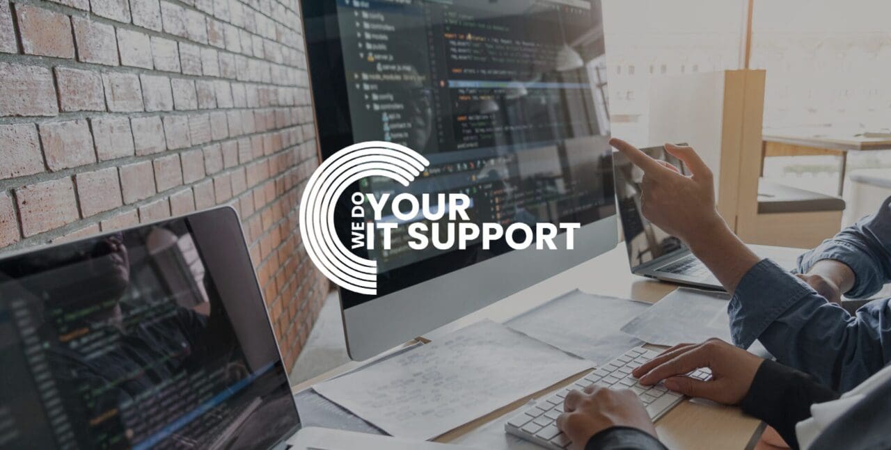 WeDoYourITSupport white logo on background with men sat at Mac monitor