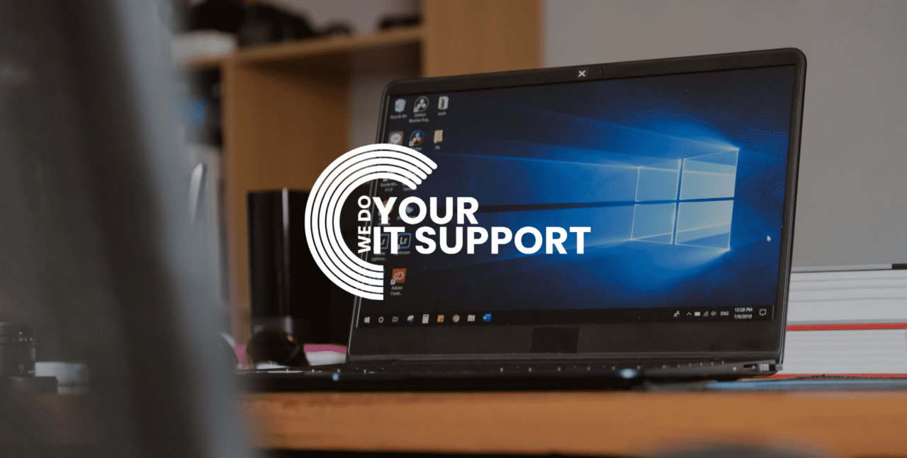 WeDoYourITSupport white logo on background of Windows laptop open with logo on screen