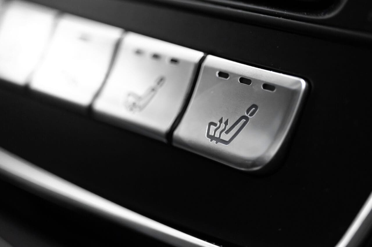 Heated seats buttons inside car. Seat heating buttons control panel in luxury car close-up view photo