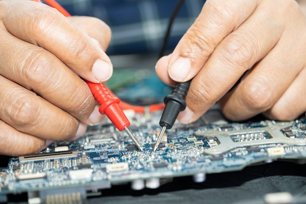 Technician repairing inside of mobile phone. Integrated Circuit.