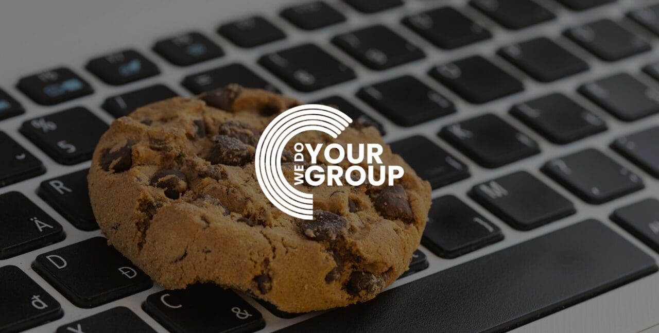 WeDoYourGroup white logo on background of cookie on mac laptop keyboard