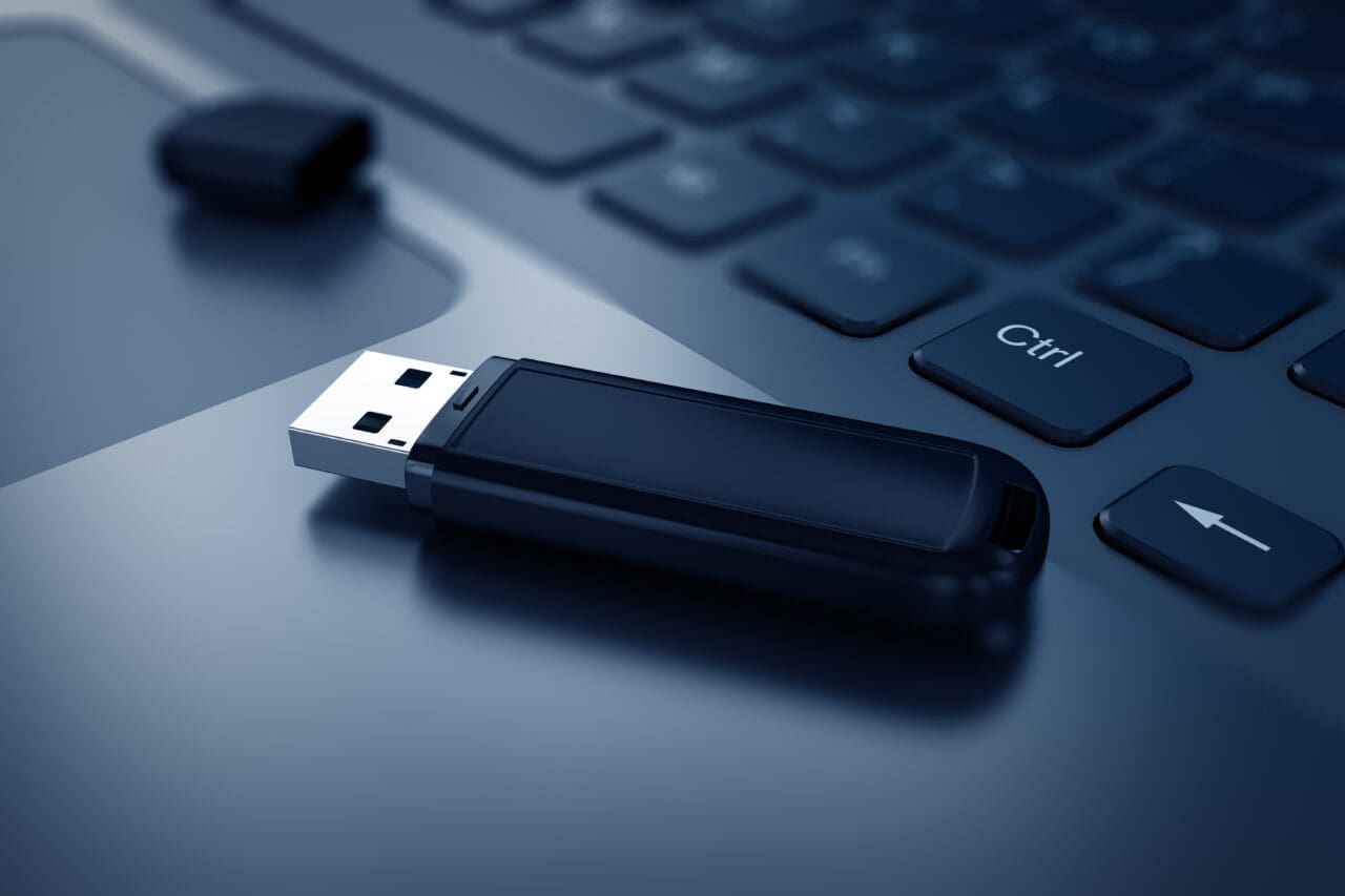 Modern USB Flash drive on laptop keyboard