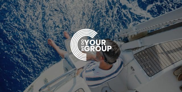 WeDoYourGroup white logo with background of man sitting on boat on blue water, with laptop on his legs