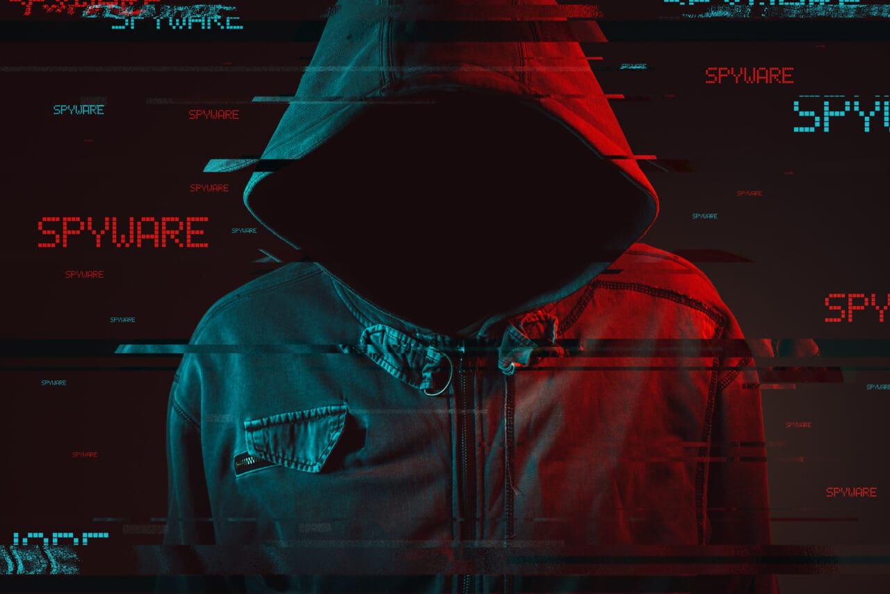 Hooded man with shadowed face, cyber hacker text overlaying