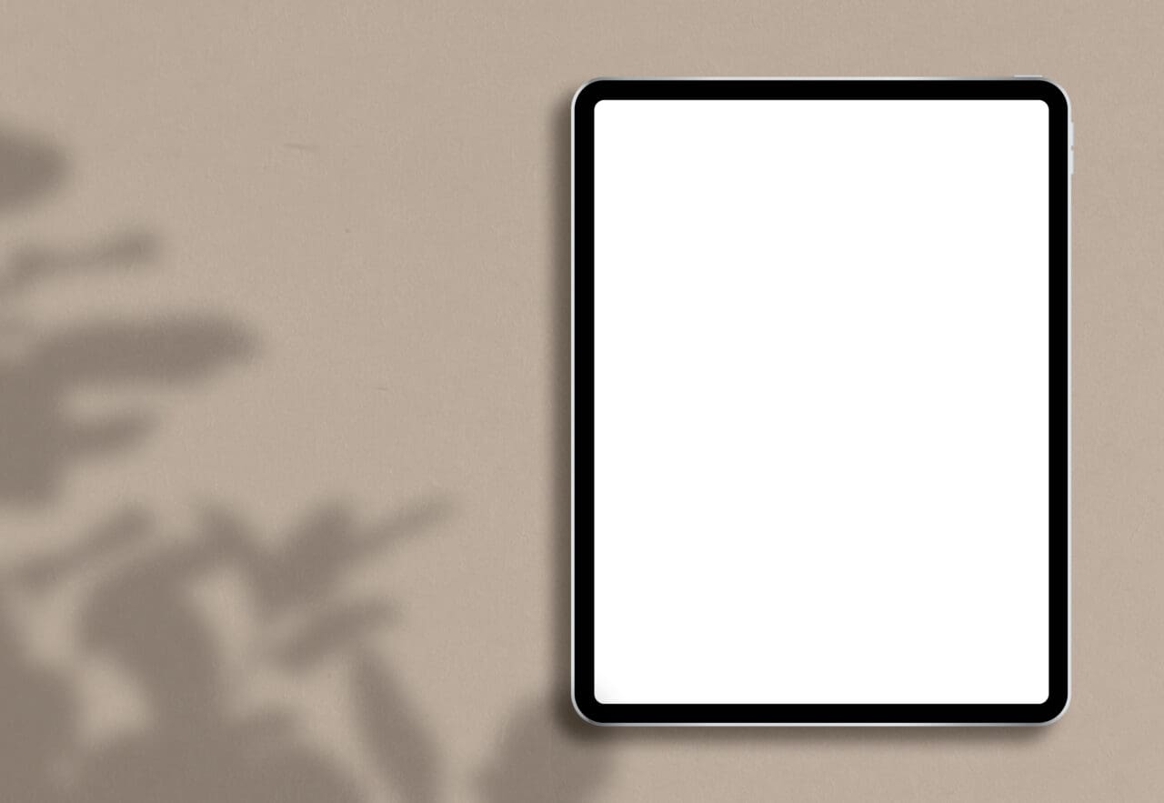 Tablet with empty screen placed on plain background