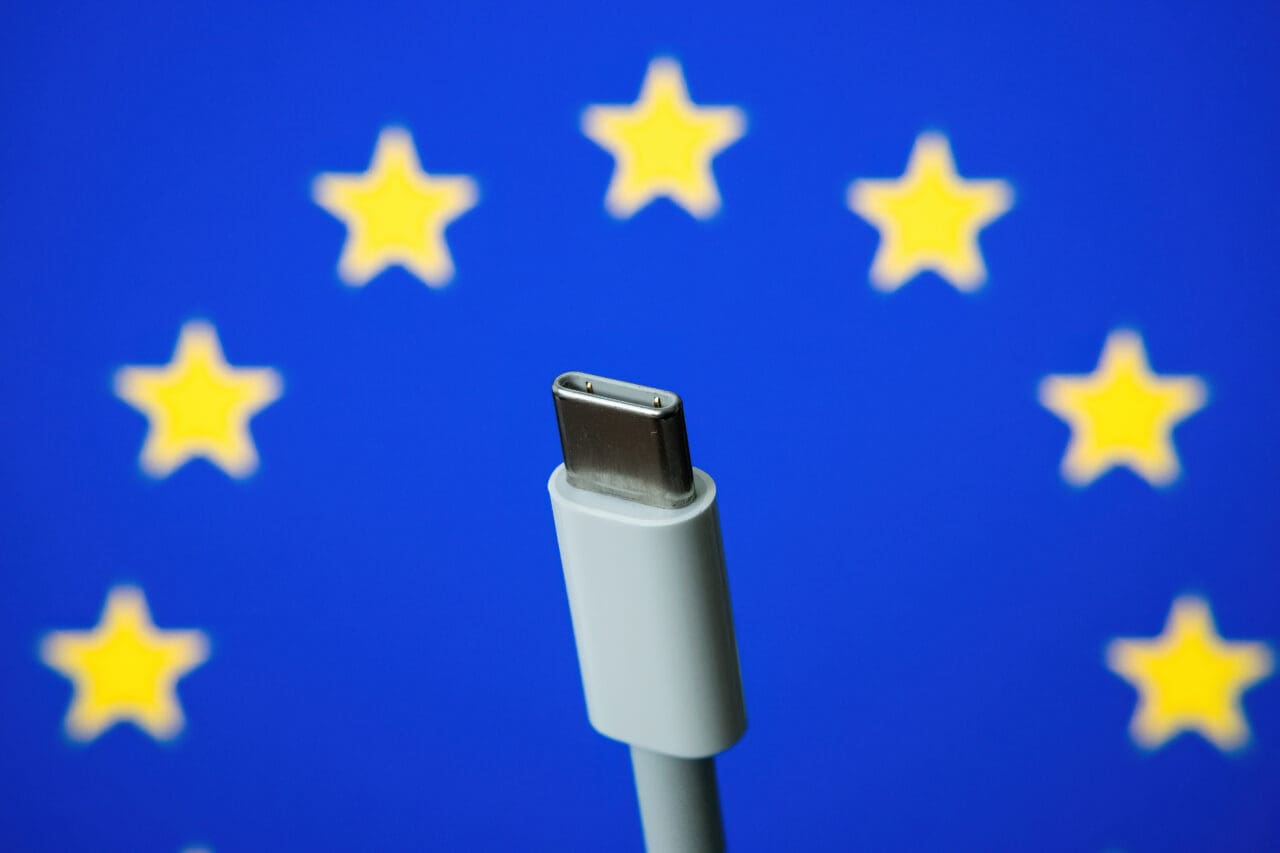 White USB-C charger with EU flag background
