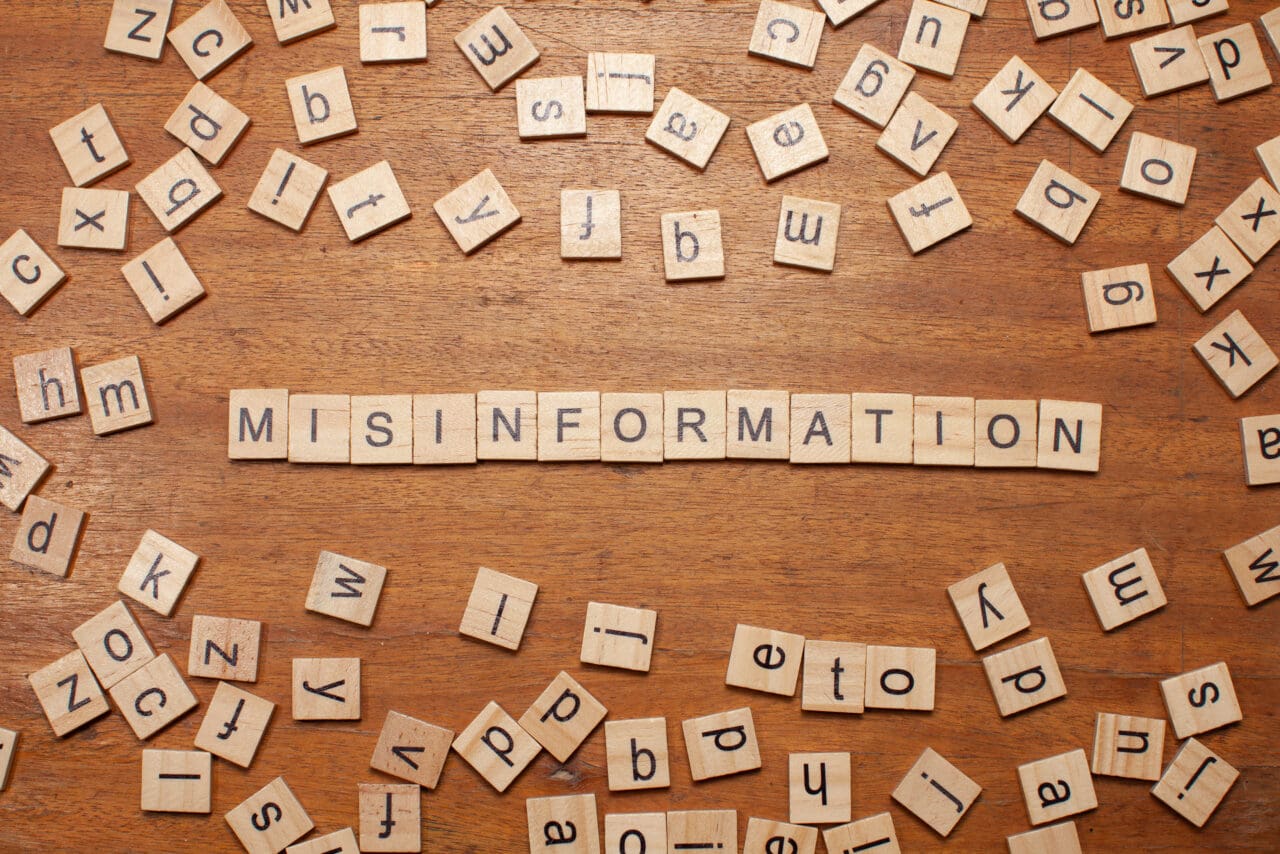 misinformation letters arranged on wooden board