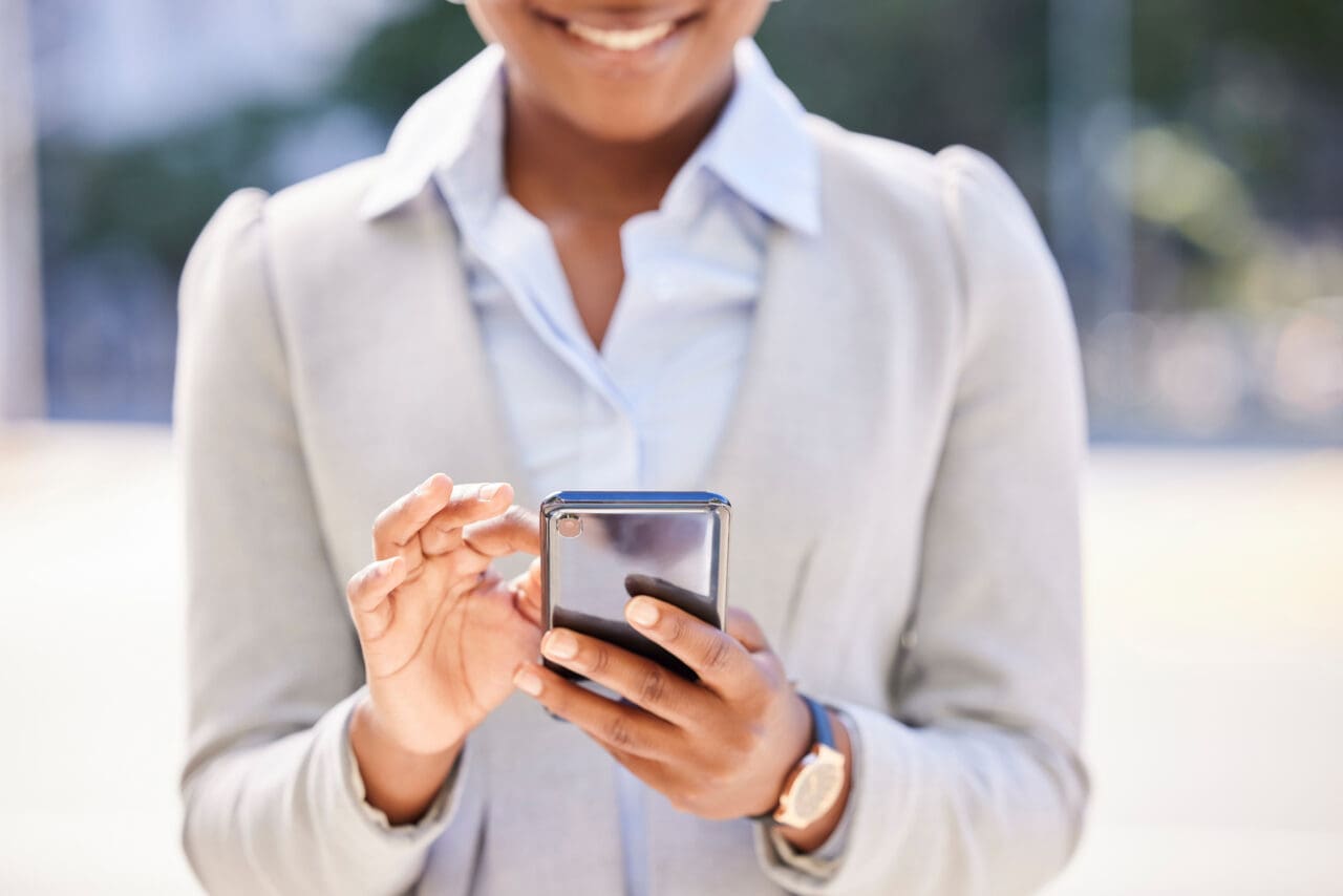 happy woman smiling at mobile phone