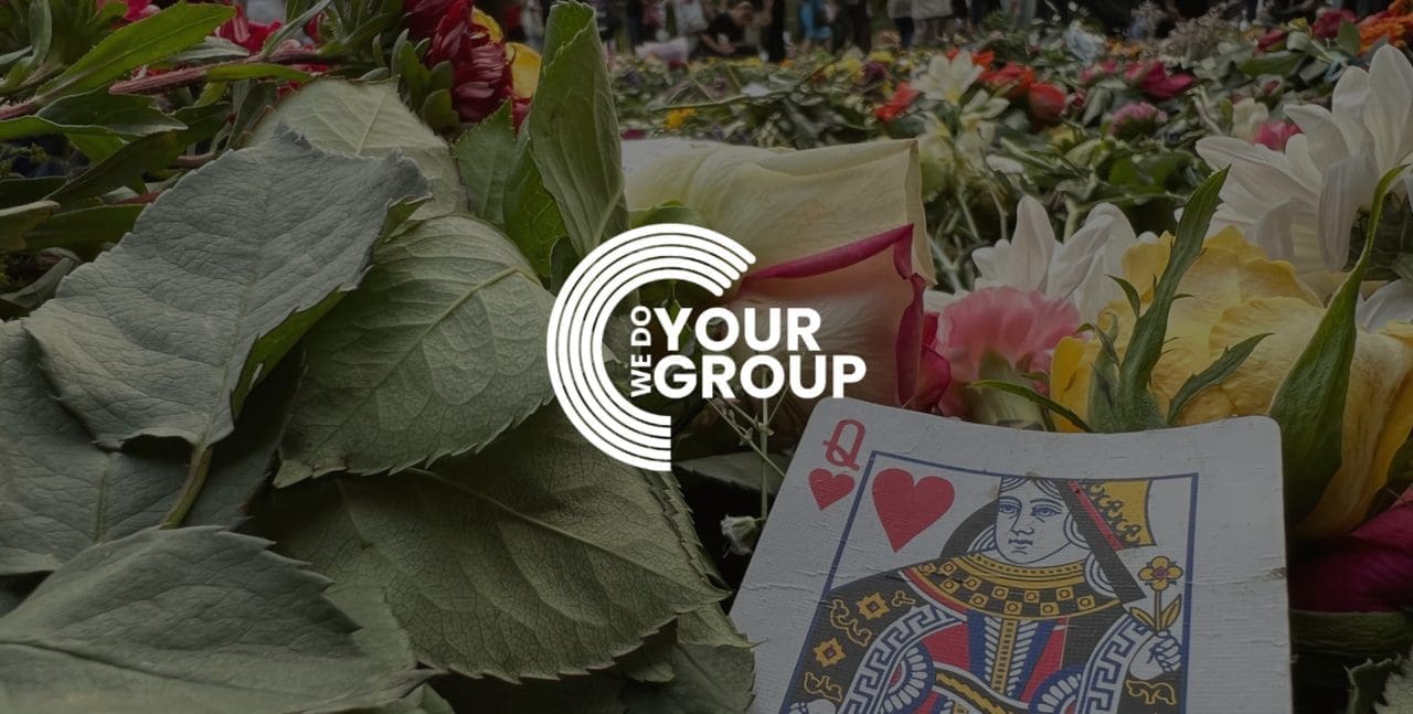 WeDoYOurGroup white logo on background with Queen playing card placed on flowers and leaves