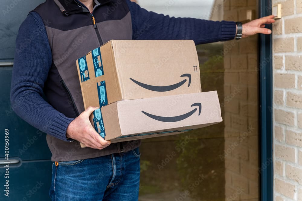 Man delivering amazon parcels to a house