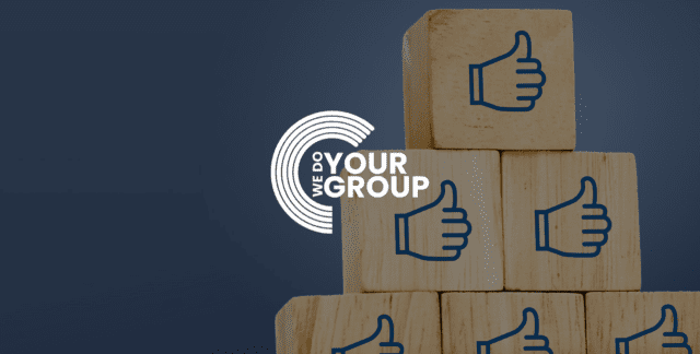 6 wooden blocks with blue thumbs up on them, with the We Do Your Group Logo