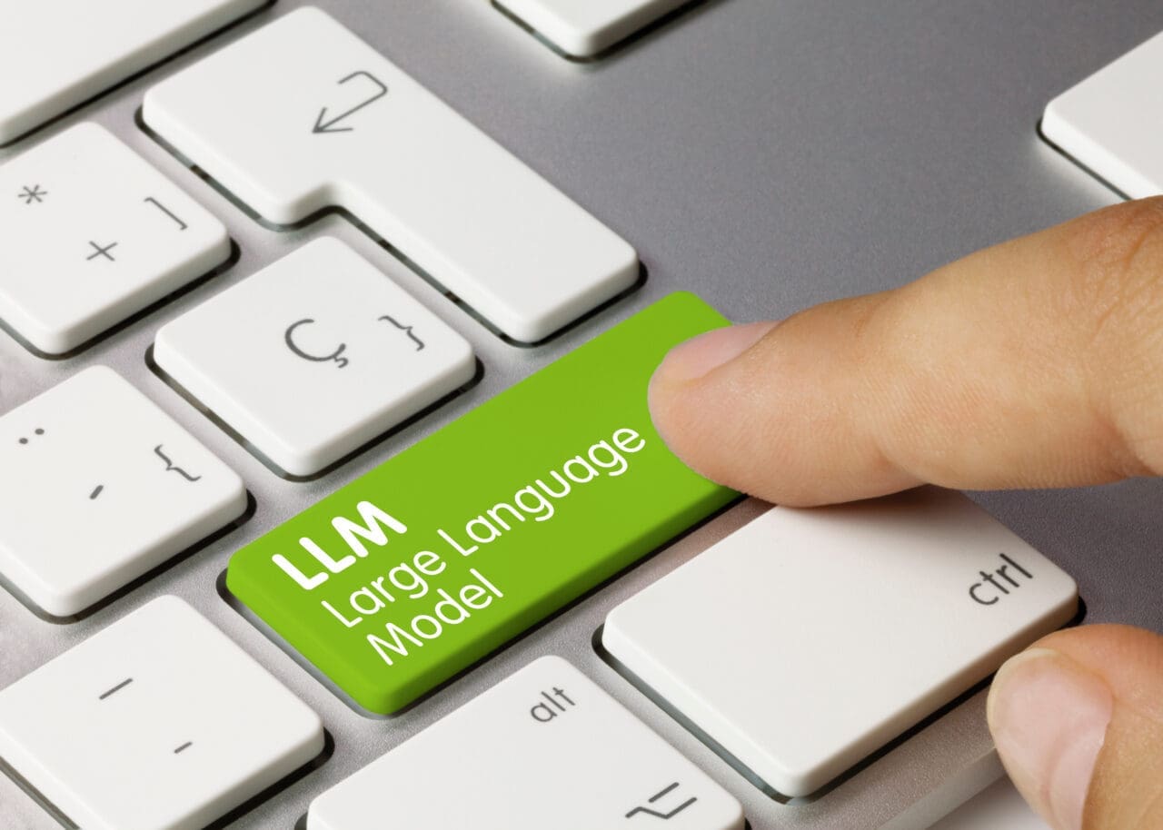 LLM Large Language Model Written on Green Key of Metallic Keyboard. Finger pressing key.