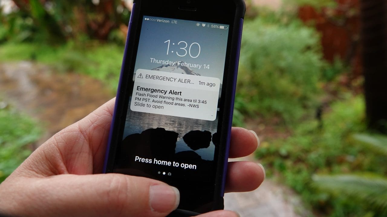 Close up of an Apple iPhone in a person's hand, displaying an em