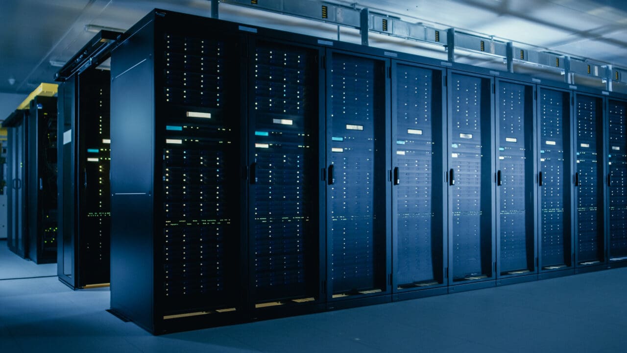 Shot of WDYG Data Center With Multiple Rows of Fully Operational Server Racks. Modern Telecommunications, Cloud Computing, Artificial Intelligence, Database, Super Computer Technology Concept.