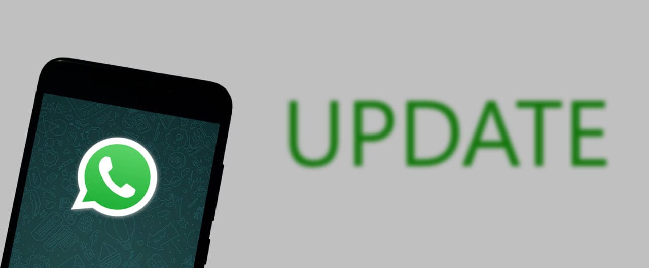 WhatsApp logo on smartphone screen with the word UPDATE on white background.