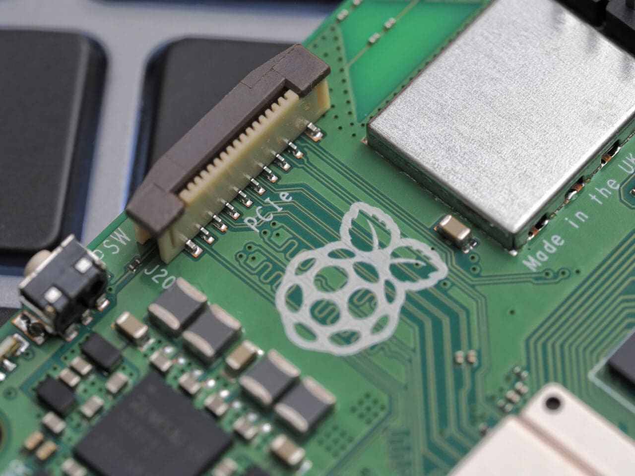 Close-up of a Raspberry Pi 5 logo on a laptop keyboard. The Raspberry Pi is a credit-card-sized single-board computer developed in the UK