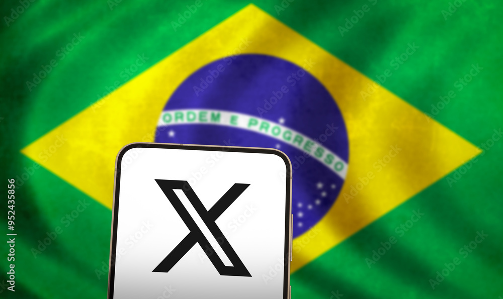 The X logo on a phone in front of a Brazilian flag